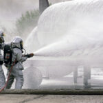 Firefighters spray aqueous film-forming foam